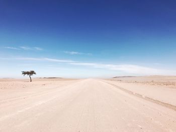 View of desert road against sky
