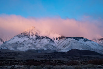 Scenic view of snowcapped mountains against sky during sunset