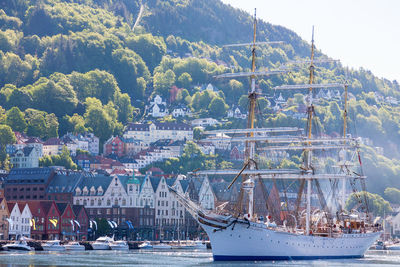 Boats moored at harbor against sky