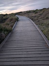 Surface level of boardwalk against sky