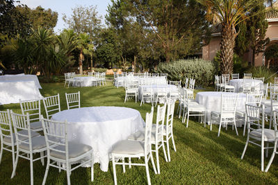 Empty chairs and tables in yard