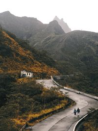 Road by mountain against sky