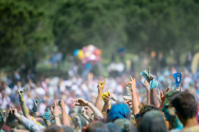 Group of people with arms raised at music concert