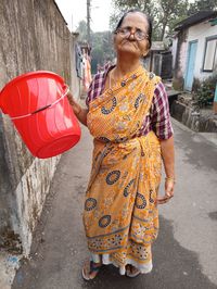 Rear view of woman standing on street