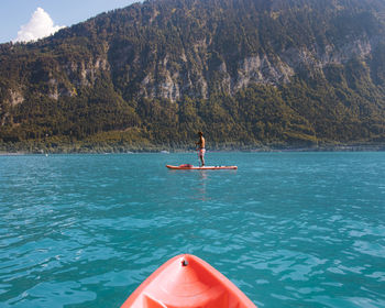 Full length of man paddleboarding in lake