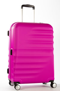 Close-up of pink camera over white background