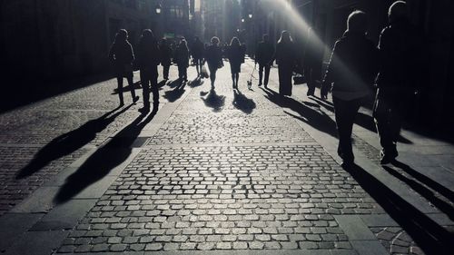 Low section of people walking on street