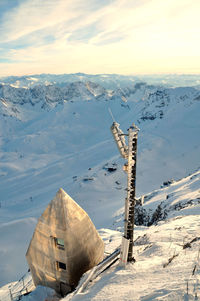 Scenic view of snow covered mountains against sky