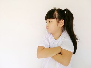 Side view of a girl looking away against white background
