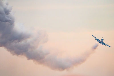 Low angle view of airplane flying in sky