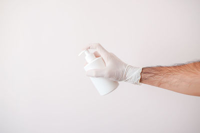 Close-up of hand holding white background