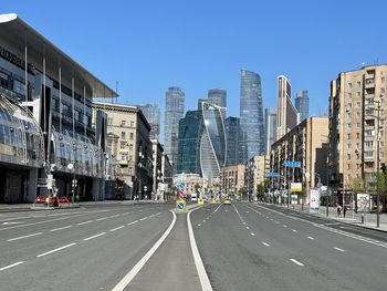 City street and modern buildings against clear sky