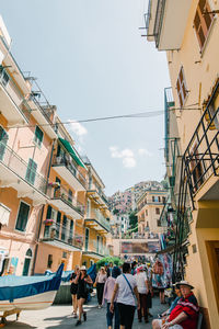 People walking on street against buildings in city