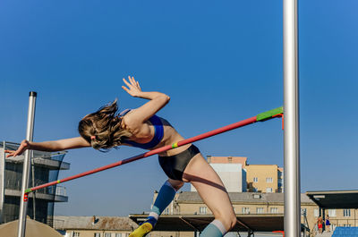 Female athlete high jump at athletics competition