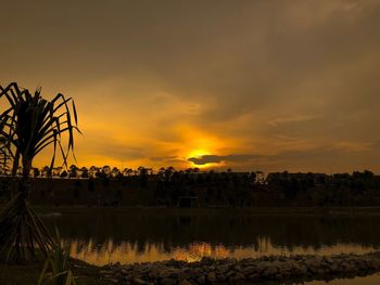 Scenic view of lake against orange sky