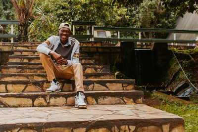 Portrait of man sitting on staircase