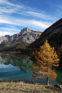 Scenic view of calm lake and mountains during autumn