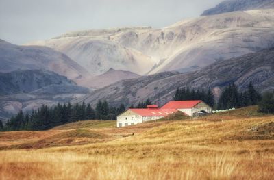 Scenic view of mountains against cloudy sky