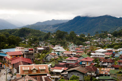 High angle view of houses and mountains against sky