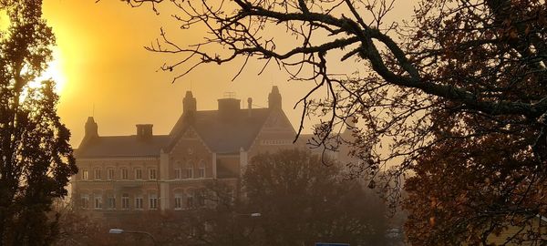 Silhouette of buildings against sky during sunset