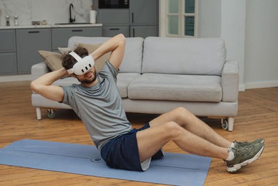 Portrait of woman sitting on sofa at home