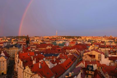 High angle view of townscape against rainbow in sky