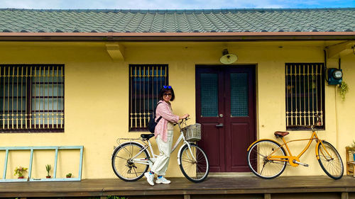 Woman riding bicycle on building