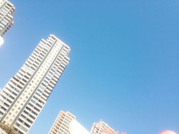 Low angle view of office building against clear sky