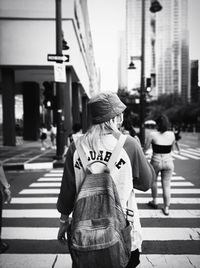 Rear view of people walking on street