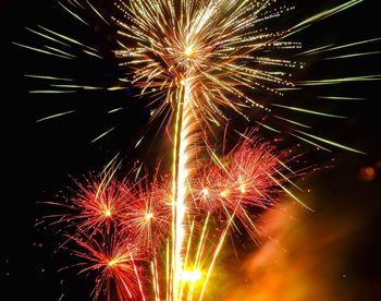 Low angle view of firework display at night