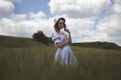 Woman standing on field against sky