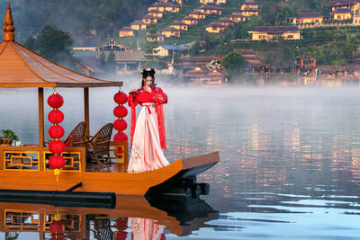 Woman standing by lake