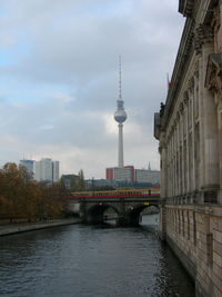 Bridge over river with buildings in background