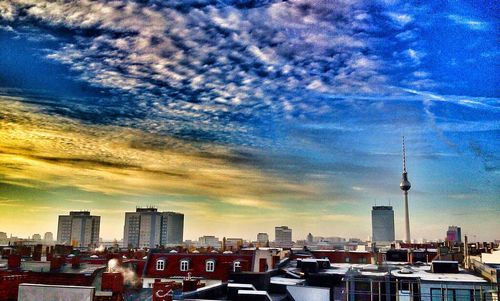 Cityscape against cloudy sky