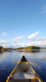 Scenic view of lake in a canoe against sky
