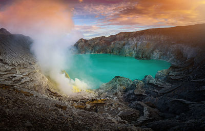 Smoke emitting from hot spring amidst mountains