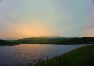 Scenic view of sea against sky at sunset
