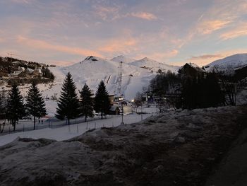 Scenic view of snowcapped mountains against sky during sunset