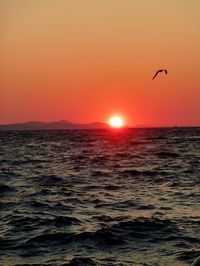 Scenic view of sea against clear sky during sunset