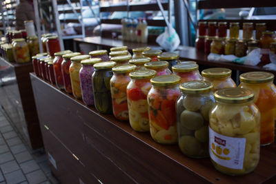 Close-up of wine bottles on shelf at market stall