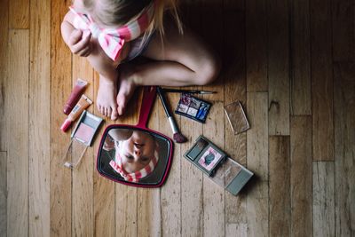 High angle view of woman using mobile phone on table