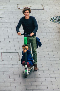 Portrait of smiling young man on footpath