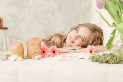 Cute smiling girl contemplating by table