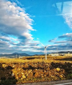 Scenic view of field against cloudy sky