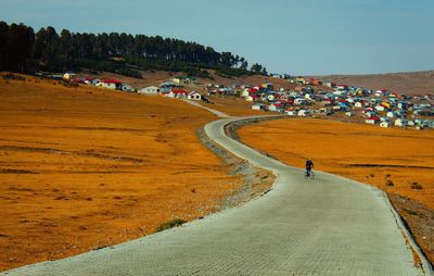 Panoramic view of road amidst landscape against sky