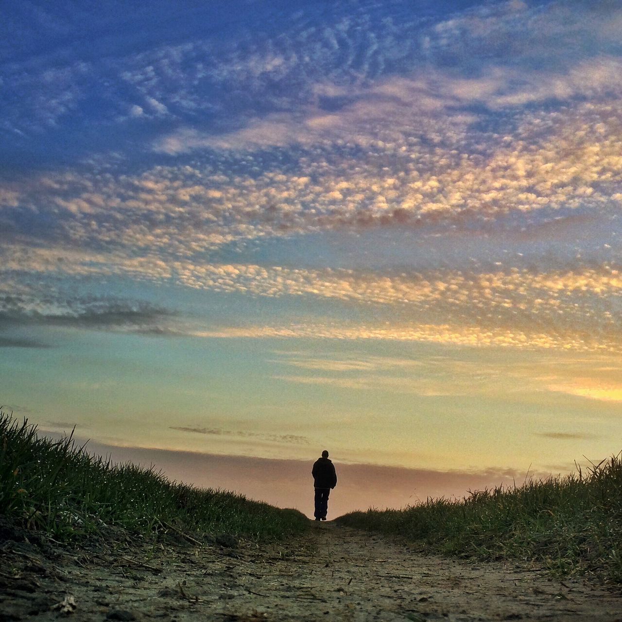 sky, tranquil scene, tranquility, sunset, scenics, beauty in nature, rear view, silhouette, standing, cloud - sky, lifestyles, leisure activity, nature, men, idyllic, full length, landscape, cloud