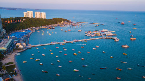 High angle view of city by sea against sky