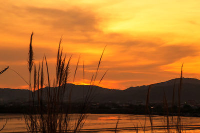 Scenic view of silhouette mountains against romantic sky at sunset