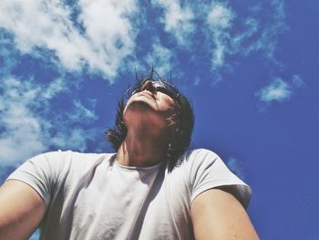 Low angle view of man against blue sky