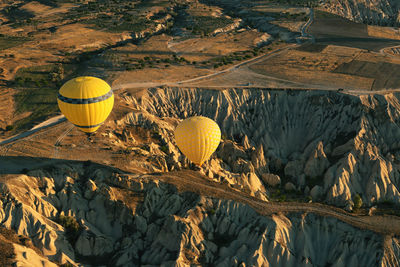 High angle view of hot air balloons over mountains at cappadocia